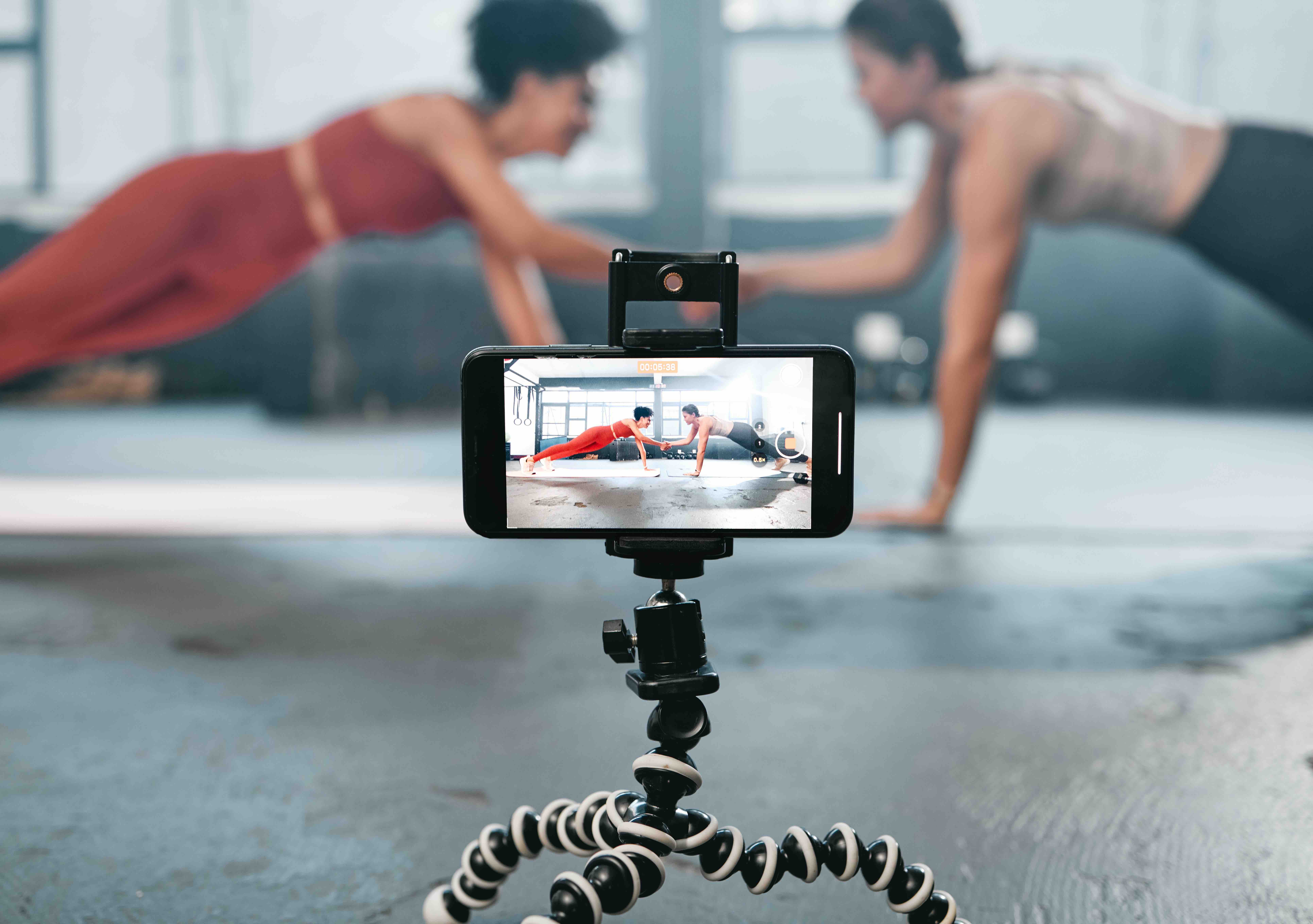 Influencer, phone and fitness people recording, filming or broadcast online training video, exercis.