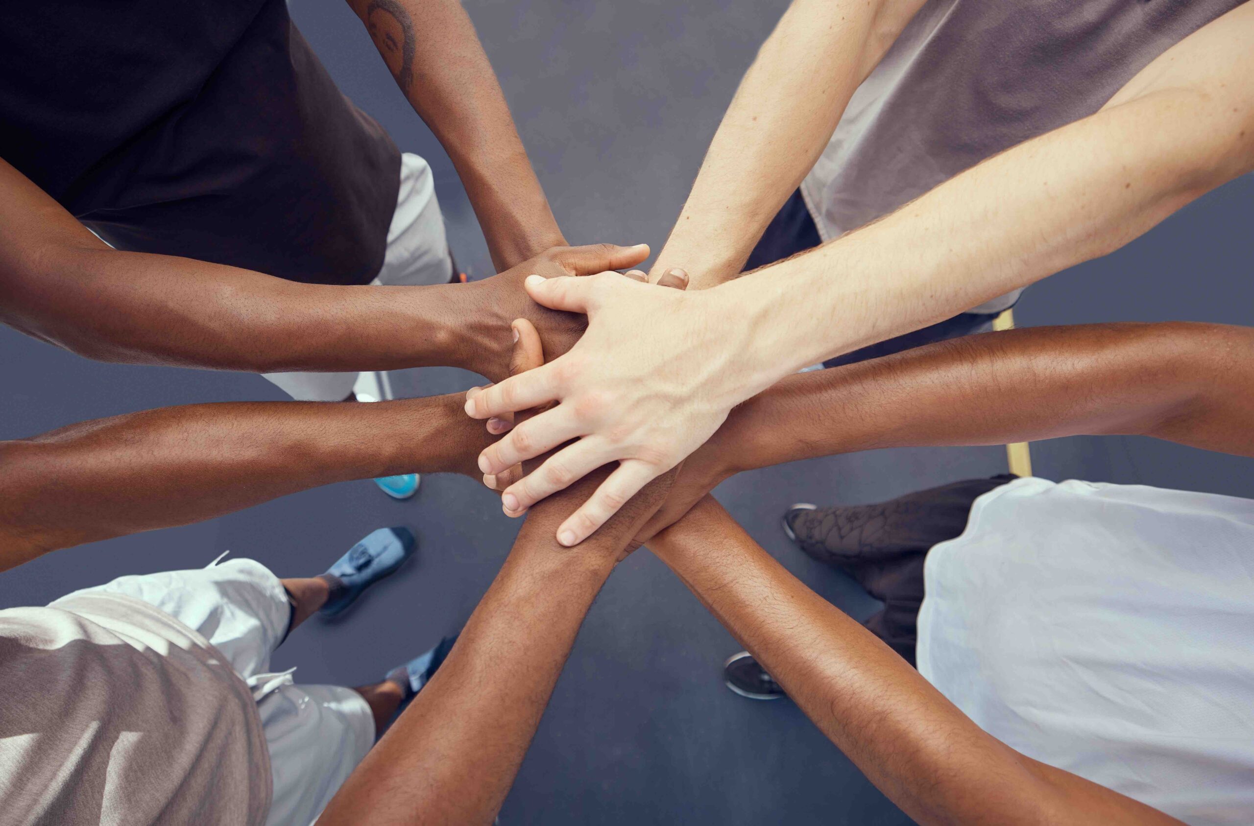 Teamwork, solidarity and diversity sports people hands stacked together from above. Athlete group o.